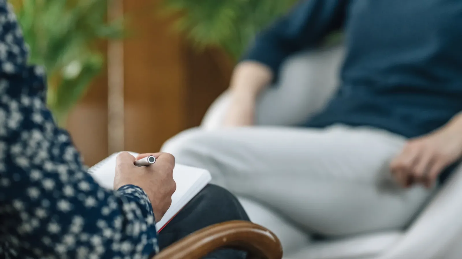 Counselor taking notes during a family therapy session